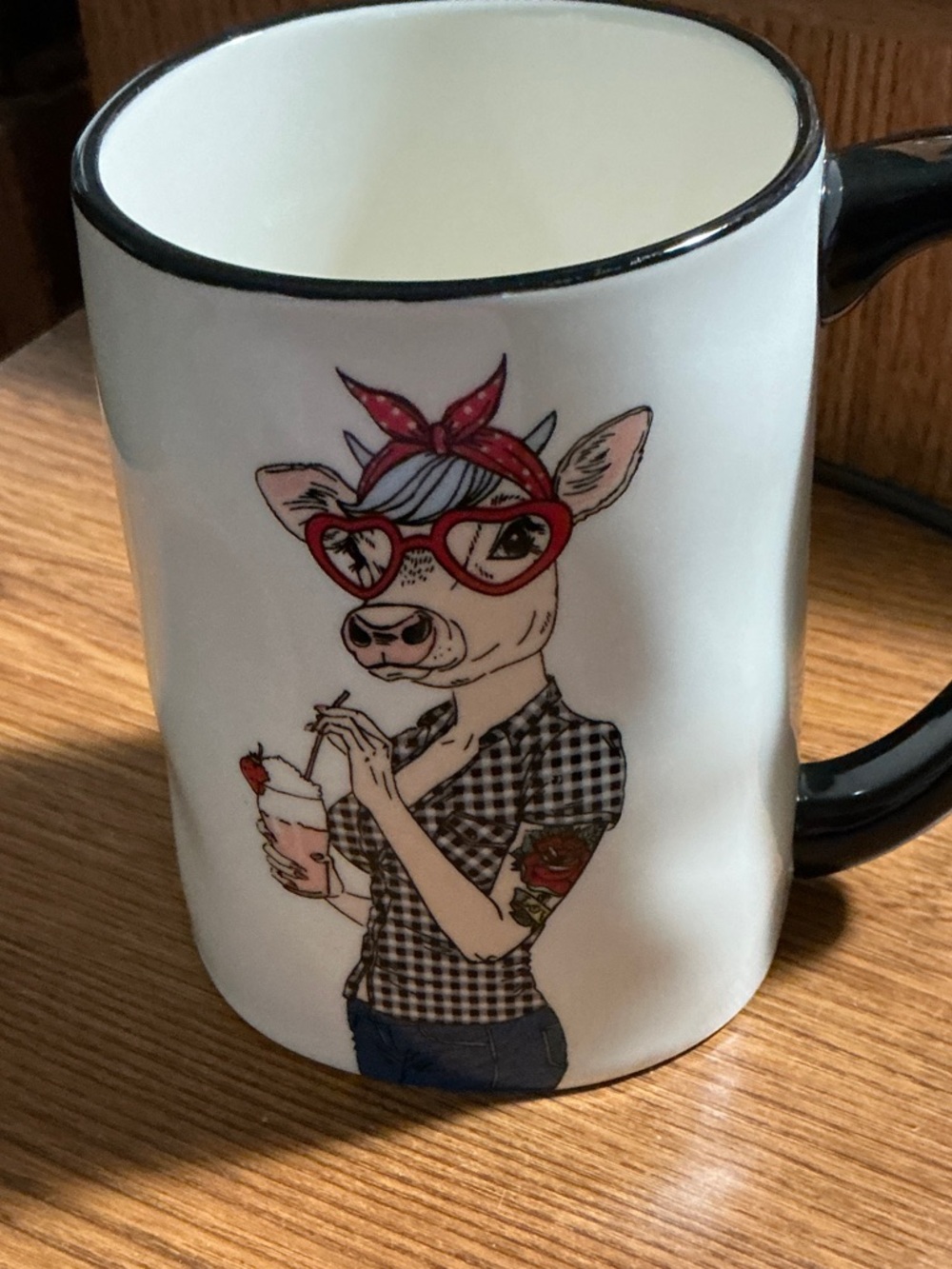 Signature stoneware Hipster Rosie Cow mug . White ceramic and black handle